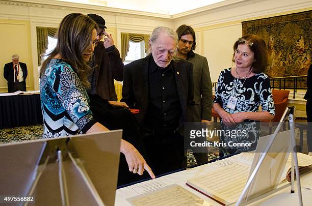 Willie Nelson with wife Annie D'Angelo check out artifacts after attending the 2015 Gershwin Prize Luncheon where he was honored with a certificate...