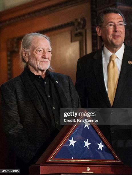 Representative Gregg Harper present Willie Nelson with an American Flag during the 2015 Gershwin Prize Luncheon Honoring Willie Nelson in the Thomas...