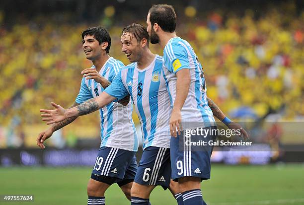 Lucas Biglia of Argentina celebrates with teammates Gonzalo Higuain and Ever Banega after scoring the opening goal during a match between Colombia...