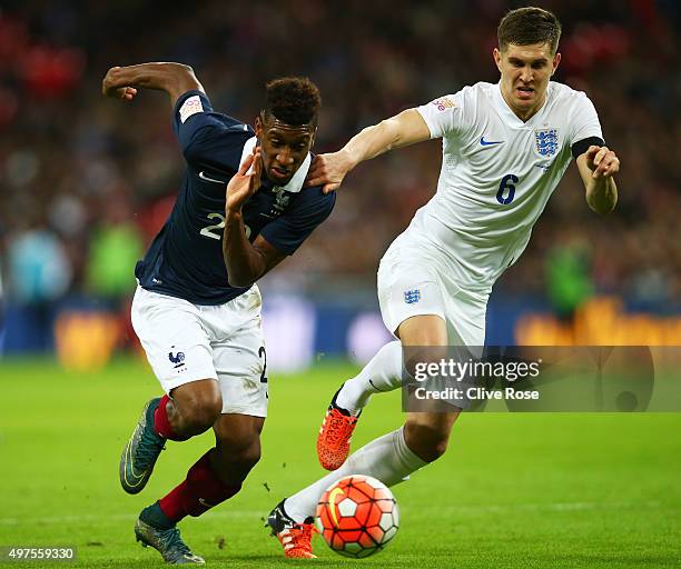 Kingsley Coman of France and John Stones of England compete for the ball during the International Friendly match between England and France at...