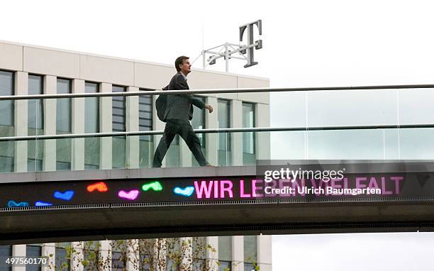 Bridge crossing between the buildings of the Telekom headquarters in Bonn with the neon sign WE LIVE DIVERSITY.