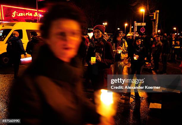 People pay tribute to the victims of Paris shortly before the match Germany against the Netherlands was cancelled following a bomb alert at the...