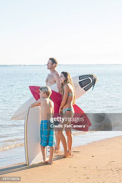 family going surfing on vacation - hawaii vacation and parent and teenager stock pictures, royalty-free photos & images