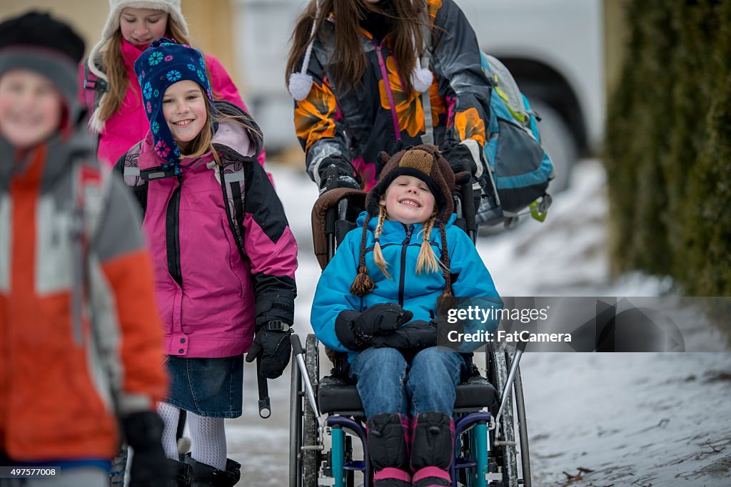 Girl Being Pushed in a Wheelchair