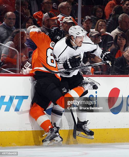 Drew Doughty of the Los Angeles Kings hits Sam Gagner of the Philadelphia Flyers into the boards during the first period at the Wells Fargo Center on...