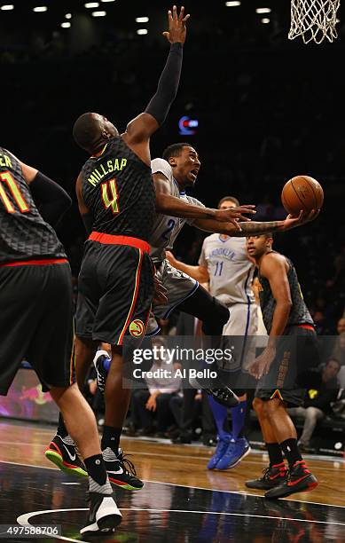 Rondae Hollis-Jefferson of the Brooklyn Nets shoots against Paul Millsap of the Atlanta Hawks during their game at The Barclays Center on November...