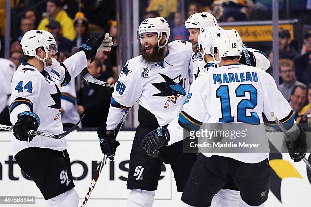 Marc-Edouard Vlasic of the San Jose Sharks, Patrick Marleau, and Brent Burns celebrate with Joe Thornton after he scored against the Boston Bruins...