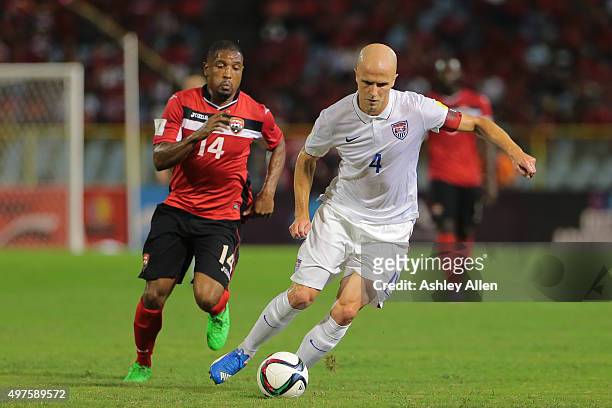 Usa's captain Michael Bradley makes an attacking run as T&T's Andre Boucaud chases during a World Cup Qualifier between Trinidad and Tobago and USA...