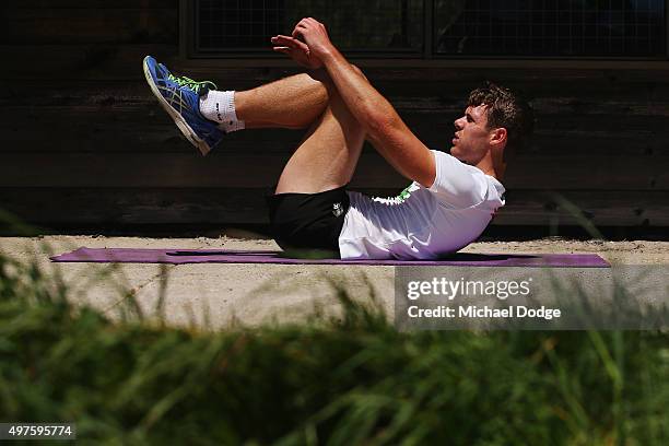 Matt Scharenberg performs sit ups as part of circuit training during a Collingwood Magpies AFL pre-season training camp at Falls Creek on November...