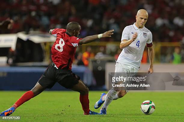 Michael Bradley beats Trinidad and Tobago's Khaleem Hyland with an attacking move to his left during a World Cup Qualifier between Trinidad and...