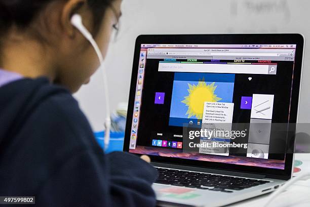 Student building an application downloads images to use on a laptop computer during a coding class at the First Code Academy in Hong Kong, China, on...
