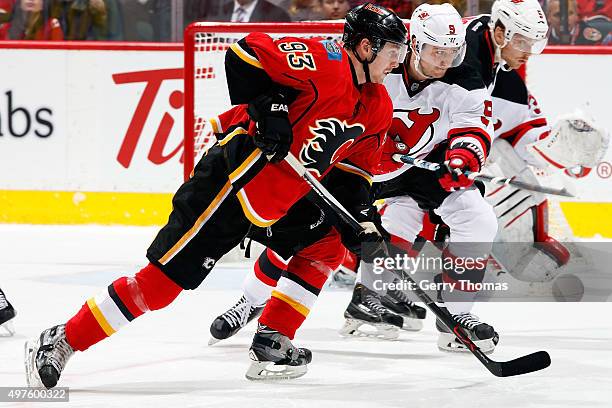 Sam Bennett of the Calgary Flames skates against Jiri Tlusty of the New Jersey Devils during an NHL game at Scotiabank Saddledome on November 17,...