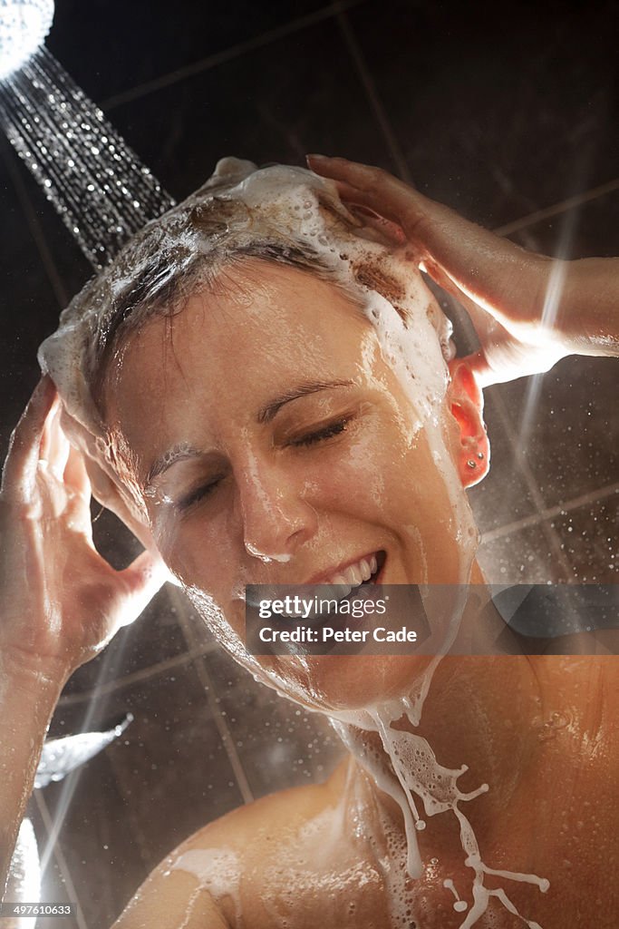 Woman in shower washing hair, close up on face