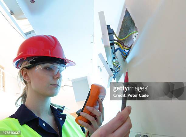 female electrician checking plug sockets - electrical equipment stock pictures, royalty-free photos & images