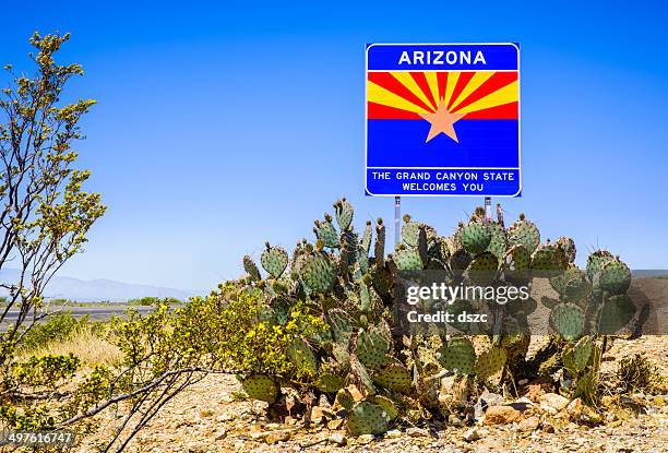 arizona state highway welcome sign with cactus, mountains, and sky - arizona flag stock pictures, royalty-free photos & images