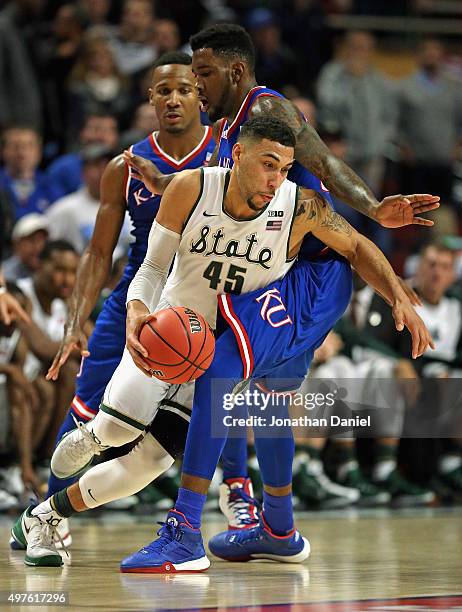 Denzel Valentine of the Michigan State Spartans moves around Jamari Traylor of the Kansas Jayhawks during the Champions Classic at the United Center...