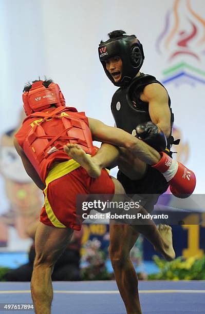 Uchit Sharma of India competes against Gunawan of Indonesia in the semi-final Men's 52kg Sanda Competition during the 2015 World Wushu Championships...