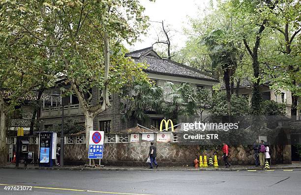 This picture taken on November 17, 2015 shows people walking past a McCafe near the famed West Lake tourist spot in the former home of late Taiwanese...