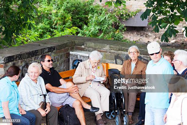 seniors having a break under tree - senior essen stock pictures, royalty-free photos & images