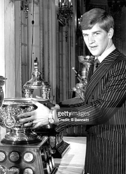 Bobby Orr of the Boston Bruins poses with the Hart, Norris and Art Ross Trophies after winning them for the regular season on May 8, 1970 in Boston,...