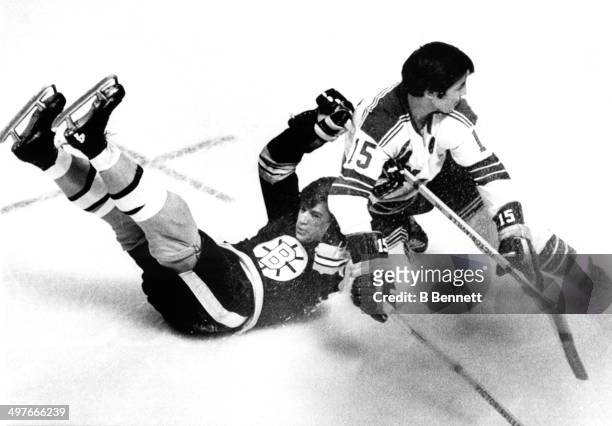 Jim Neilson of the New York Rangers checks Bobby Orr of the Boston Bruins during Game 2 of the 1970 Quarter Finals on April 9, 1970 at the Boston...