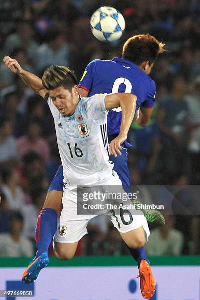 Hotaru Yamaguchi of Japan and Khuon Laboravy of Cambodia compete for the ball during the 2018 FIFA World Cup Qualifier match between Cambodia and...
