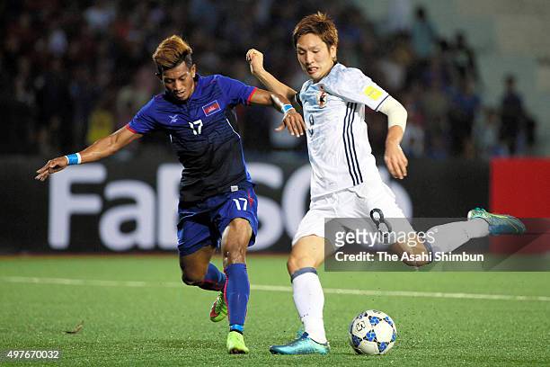 Genki Haraguchi of Japan and Chhin Chhoeun of Cambodia compete for the ball during the 2018 FIFA World Cup Qualifier match between Cambodia and Japan...