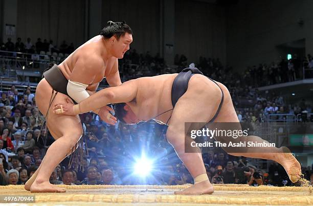 Mongolian yokozuna Hakuho throws ozeki Kisenosato to win during day eleven of the Grand Sumo Kyushu Tournament at Fukuoka Convention Center on...