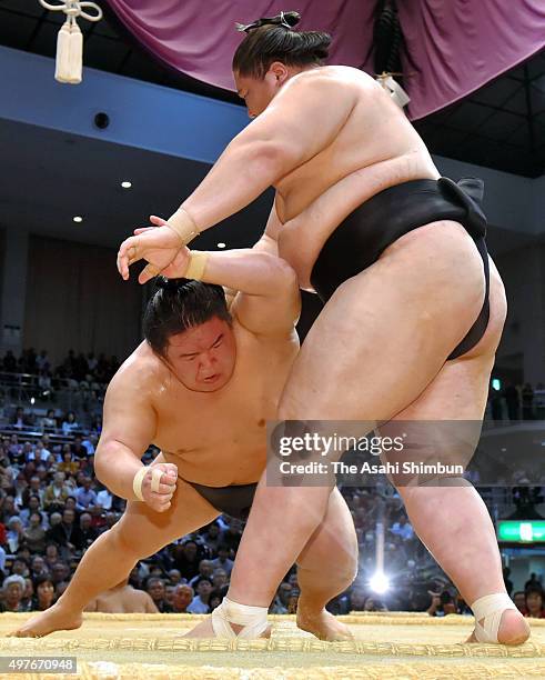 Mongolian wrestler Ichinojo throws ozeki Goeido to win during day eleven of the Grand Sumo Kyushu Tournament at Fukuoka Convention Center on November...