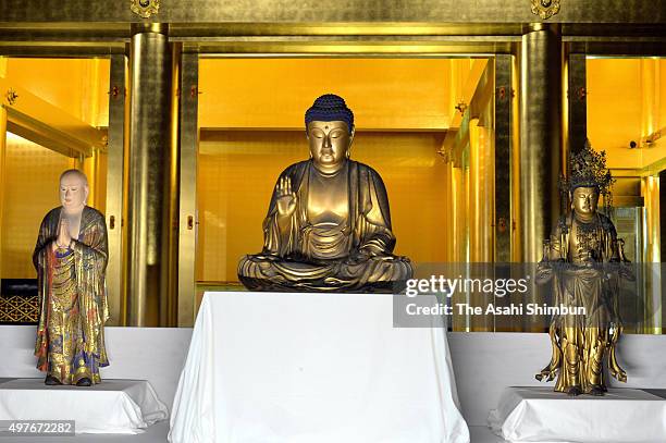 Three Buddha statues, which is usually not open to the public and placed in the Founder's Hall are seen ahead of the public opening at the Amida Hall...