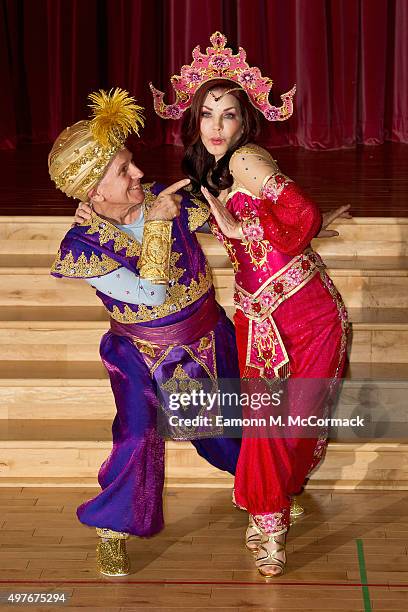 Wayne Sleep and Priscilla Presley pose during a photocall for "Aladdin" at Milton Keynes Theatre on November 18, 2015 in Milton Keynes, England.