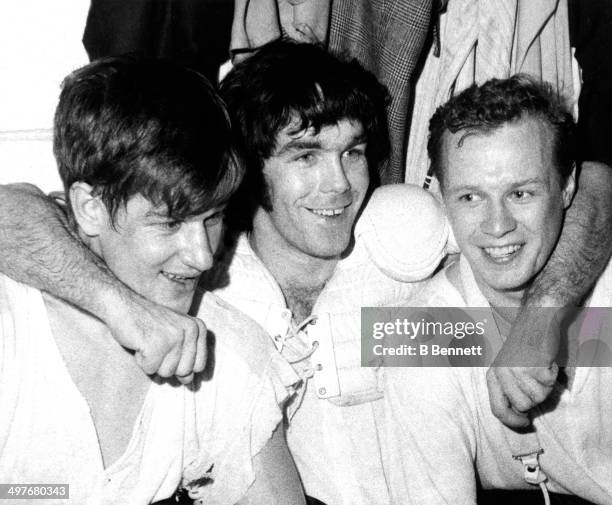 Bobby Orr, Derek Sanderson and Wayne Cashman of the Boston Bruins celebrate in the locker room after defeating the New York Rangers in Game 6 of the...