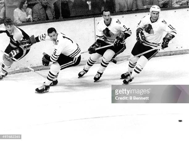 Bobby Orr of the Boston Bruins is defended by Eric Nesterenko, Bill White and Doug Mohns of the Chicago Blackhawks during Game 3 of the 1970...