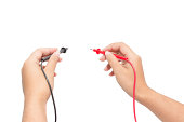 Electrician holding probes from voltmeter
