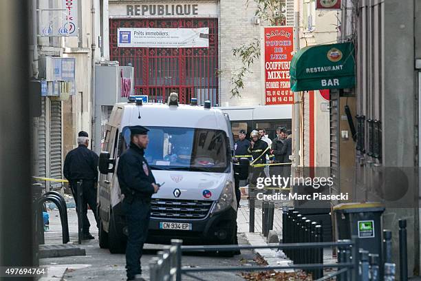 French Police Forensics officers and firefighters work on Rue des Corbillon in the northern Paris suburb of Saint-Denis following a raid on an...