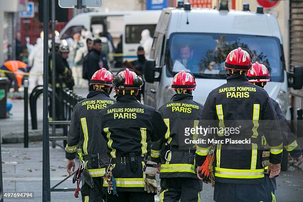 Parisian Firefighters work on Rue des Corbillon in the northern Paris suburb of Saint-Denis following a raid on an apartment on November 18, 2015 in...