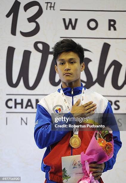 Arnel Mandal of Philippines celebrates with his gold medal on the podium during the Men's 52kg Sanda Competition medals ceremony of the 2015 World...