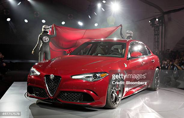 The 2017 Alfa Romeo Giulia Quadrifoglio vehicle sits on stage during its North American debut during the Los Angeles Auto Show in Los Angeles,...