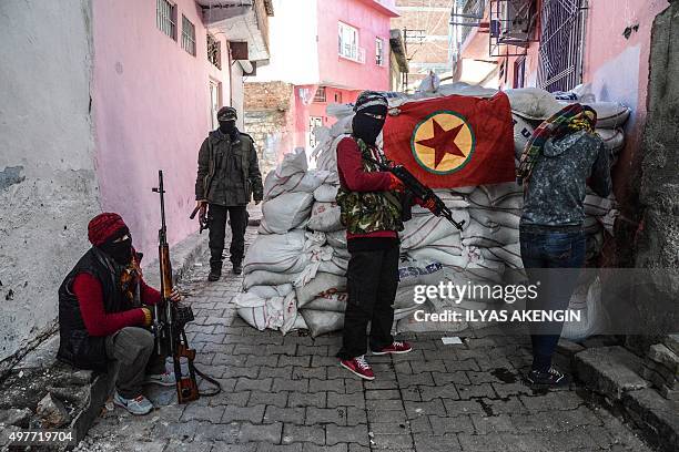 Flag of Kurdish workers Party hangs on a barricade as armed kurdish militants man a barricade, on November 18, 2015 in the Sur district of...