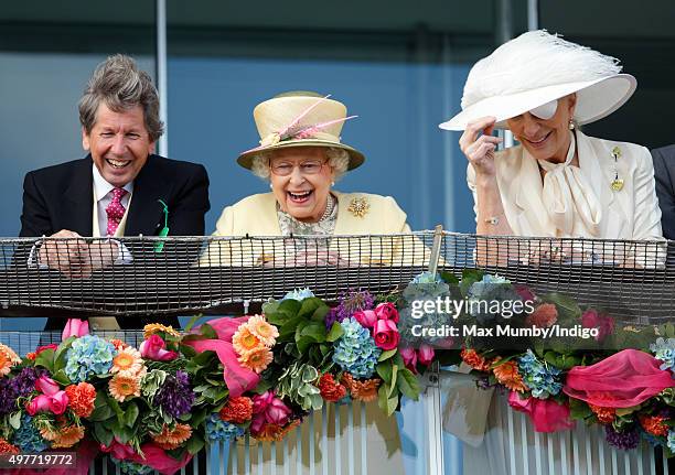 Queen Elizabeth II, her racing manager John Warren and Princess Michael of Kent watch the racing from the balcony of the Royal Box as they attend...