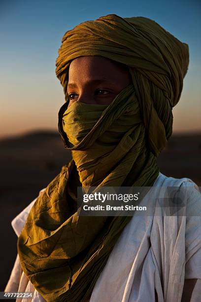 Young Tuareg artisan boy, Anara Ag Hamay Cisse, 13 years old, stands in the dunes on January 18, 2010 outside of Timbuktu, the mythical Northern Mali...