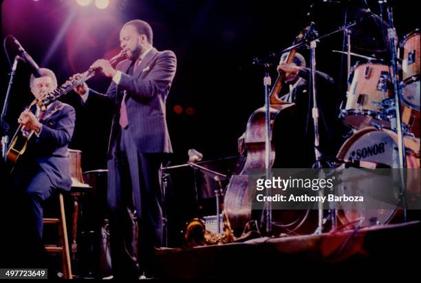 From left, American jazz musicians Kenny Burrell, on guitar, Grover Washington Jr , on saxophone, and Reggie Workman, on bass, perform on stage...