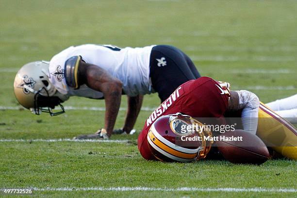 Cornerback Keenan Lewis of the New Orleans Saints and wide receiver DeSean Jackson of the Washington Redskins lay injured on the ground in the second...