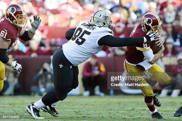 Quarterback Kirk Cousins of the Washington Redskins is tackled by defensive tackle Tyeler Davison of the New Orleans Saints in the second quarter at...