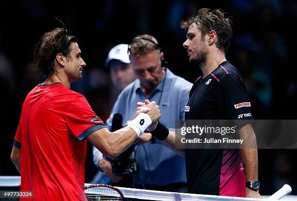 Stan Wawrinka of Switzerland shakes hands with David Ferrer of Spain after his victory in their men's singles match during day four of the Barclays...