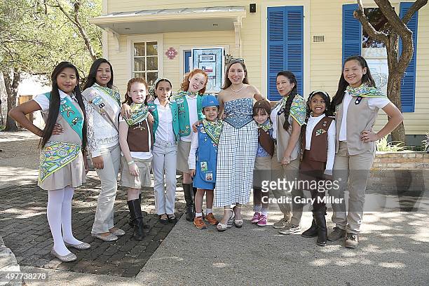 Fashion designer Marisol Deluna poses with Girl Scouts as Marisol Deluna New York Celebrates the Grand Opening Of Design Studio And Educational...