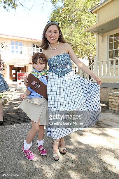 Fashion designer Marisol Deluna poses with a Girl Scout as Marisol Deluna New York Celebrates the Grand Opening Of Design Studio And Educational...