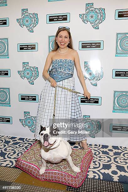 Fashion designer Marisol Deluna and Rubble the dog pose on the red carpet as Marisol Deluna New York Celebrates the Grand Opening Of Design Studio...