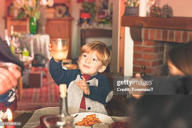 criança é segurando o vidro de feliz ano novo de tostar - table dinner winter imagens e fotografias de stock