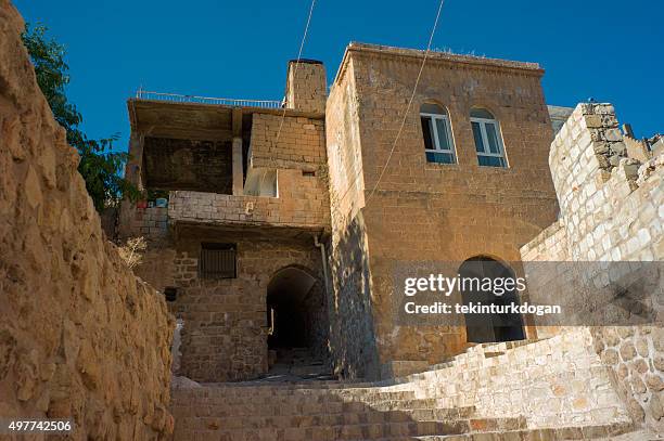 traditional under street passage with stone houses of mardin turkey - touristical stock pictures, royalty-free photos & images